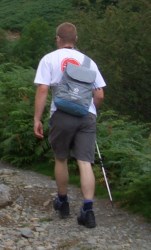 Walker equipped with walking pole, rucksack and sturdy boots